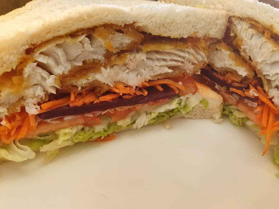 Fish Sandwich with Vegetables on White Bread Cut in Half — Mount Louisa Snack Bar in Mount Louisa, QLD