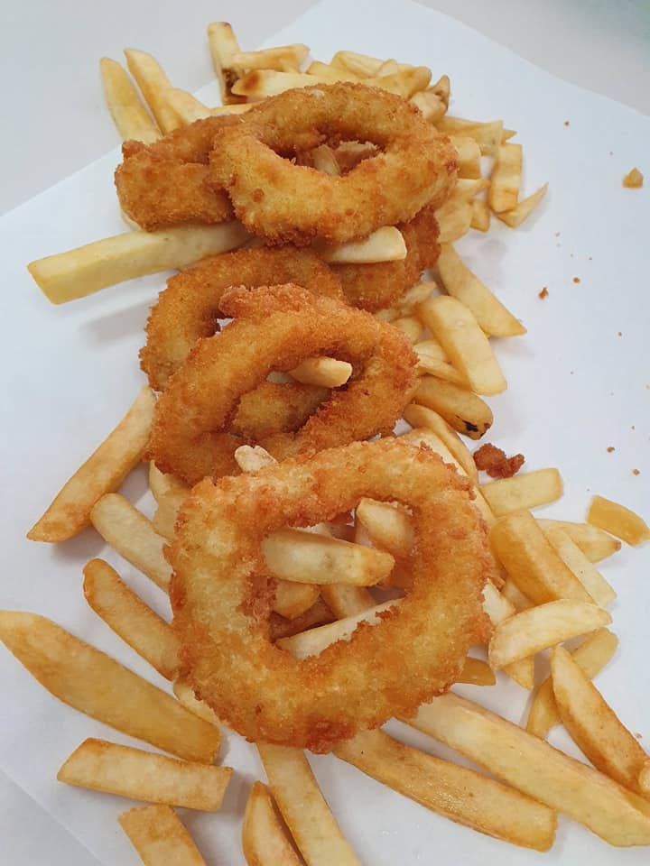 Golden Fried Onion Rings and French Fries on A White Surface — Mount Louisa Snack Bar in Mount Louisa, QLD
