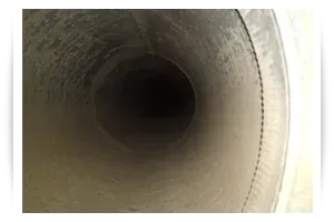 A close up of a dirty duct with a hole in the middle. A close up of a dirty duct with a hole in the middle.