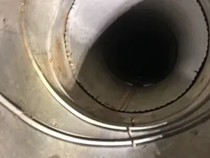 A close up of a metal pipe with a hole in the middle. A close up of a metal pipe with a hole in the middle.