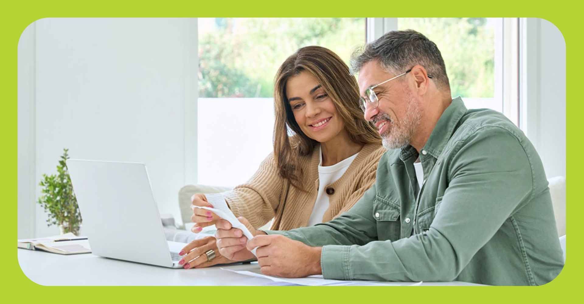 Man and woman looking over paperwork in a home setting