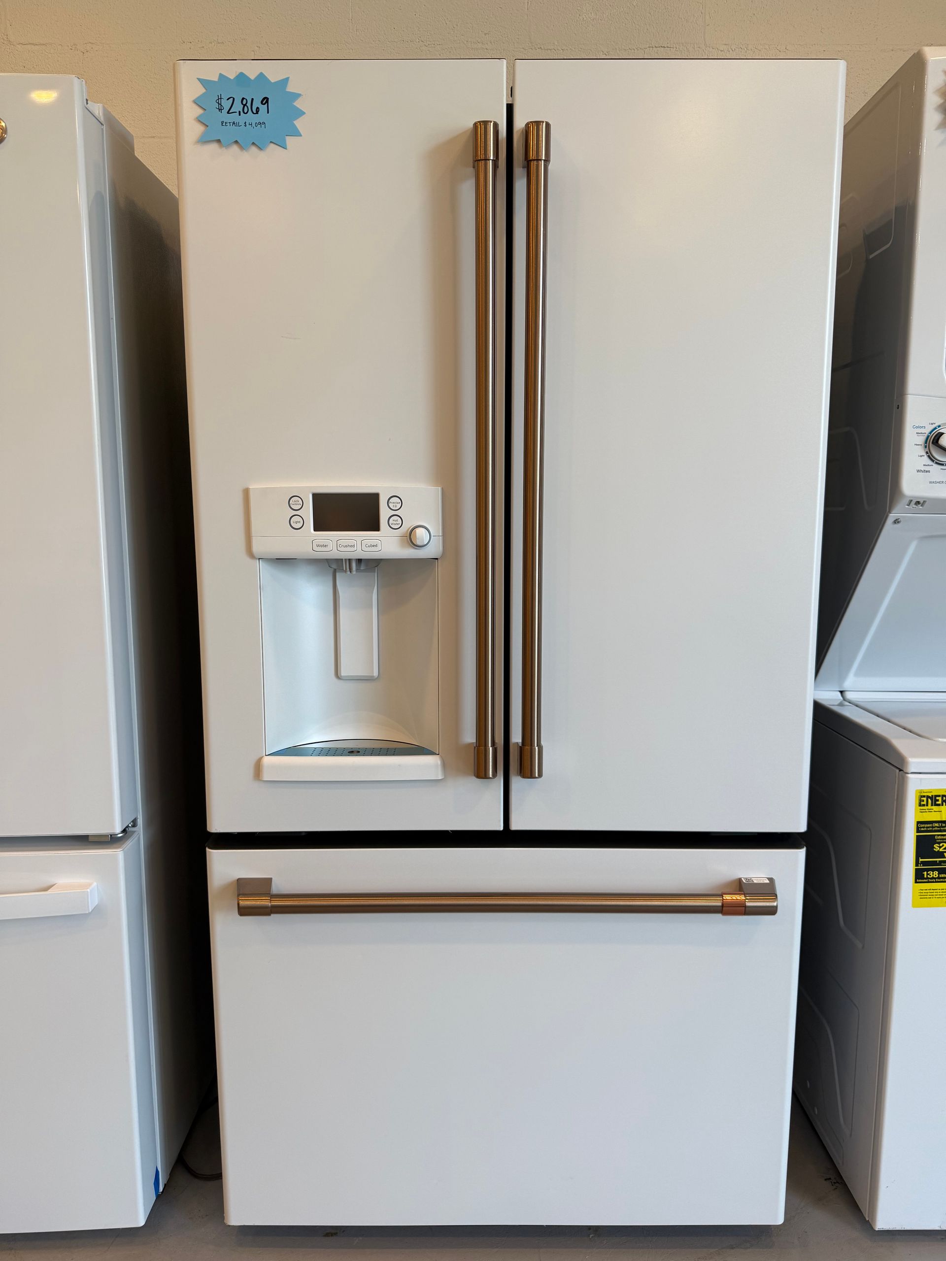 A white refrigerator with a price tag on it