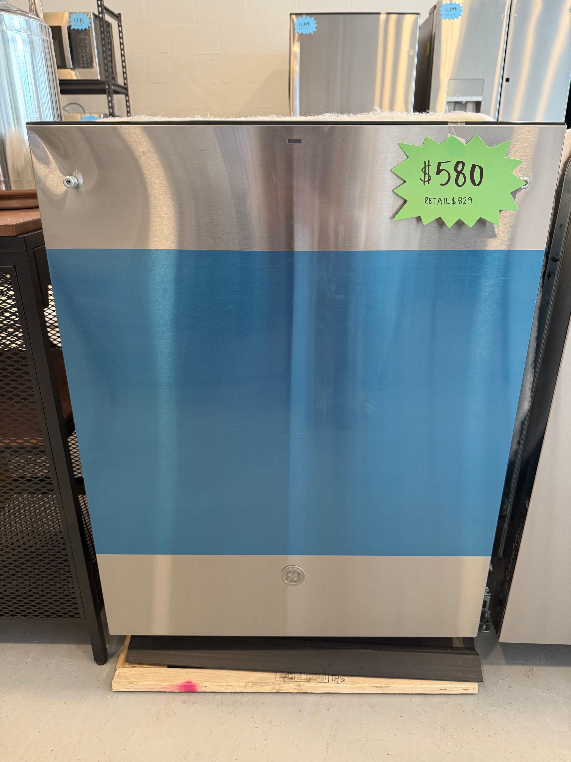 A stainless steel refrigerator with a price tag on it.