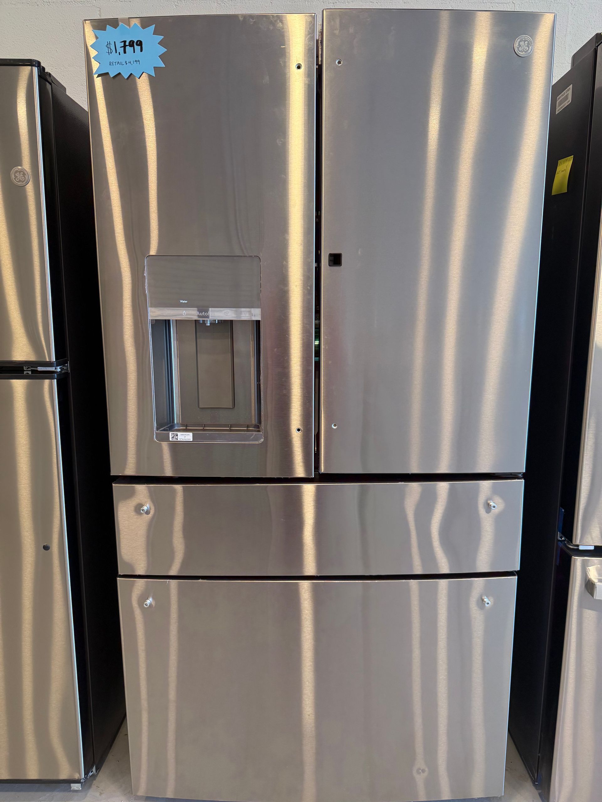 A stainless steel refrigerator with a price tag on it