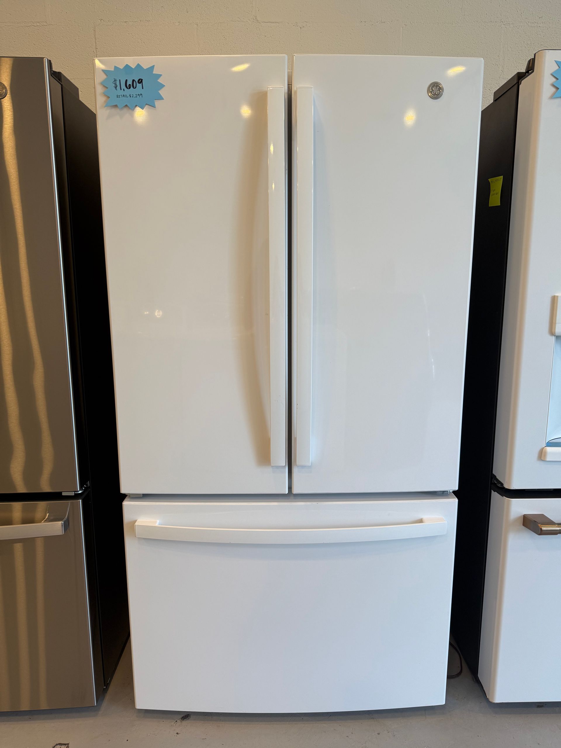 A white refrigerator with a price tag on it