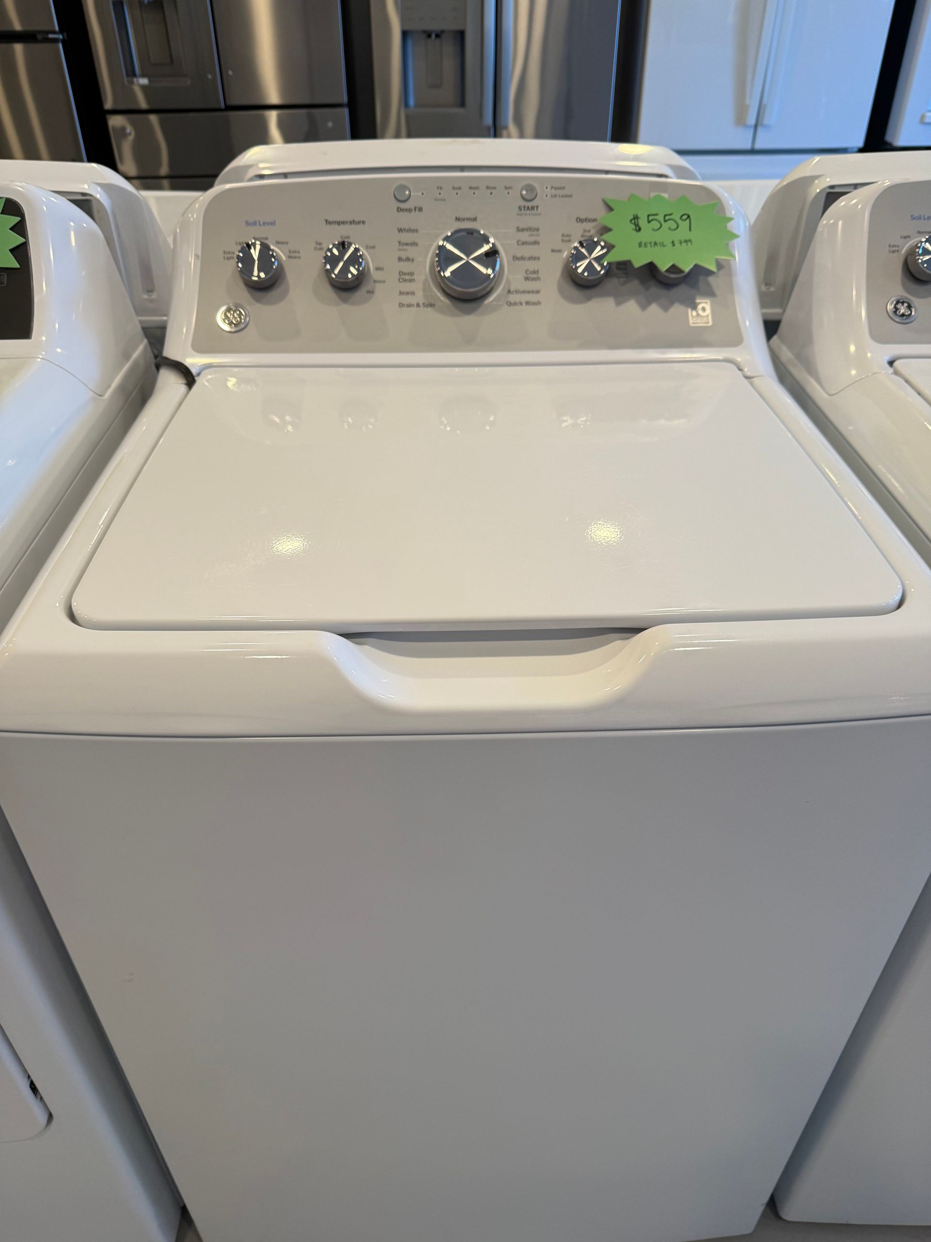 A white washer and dryer are sitting next to each other in a store.