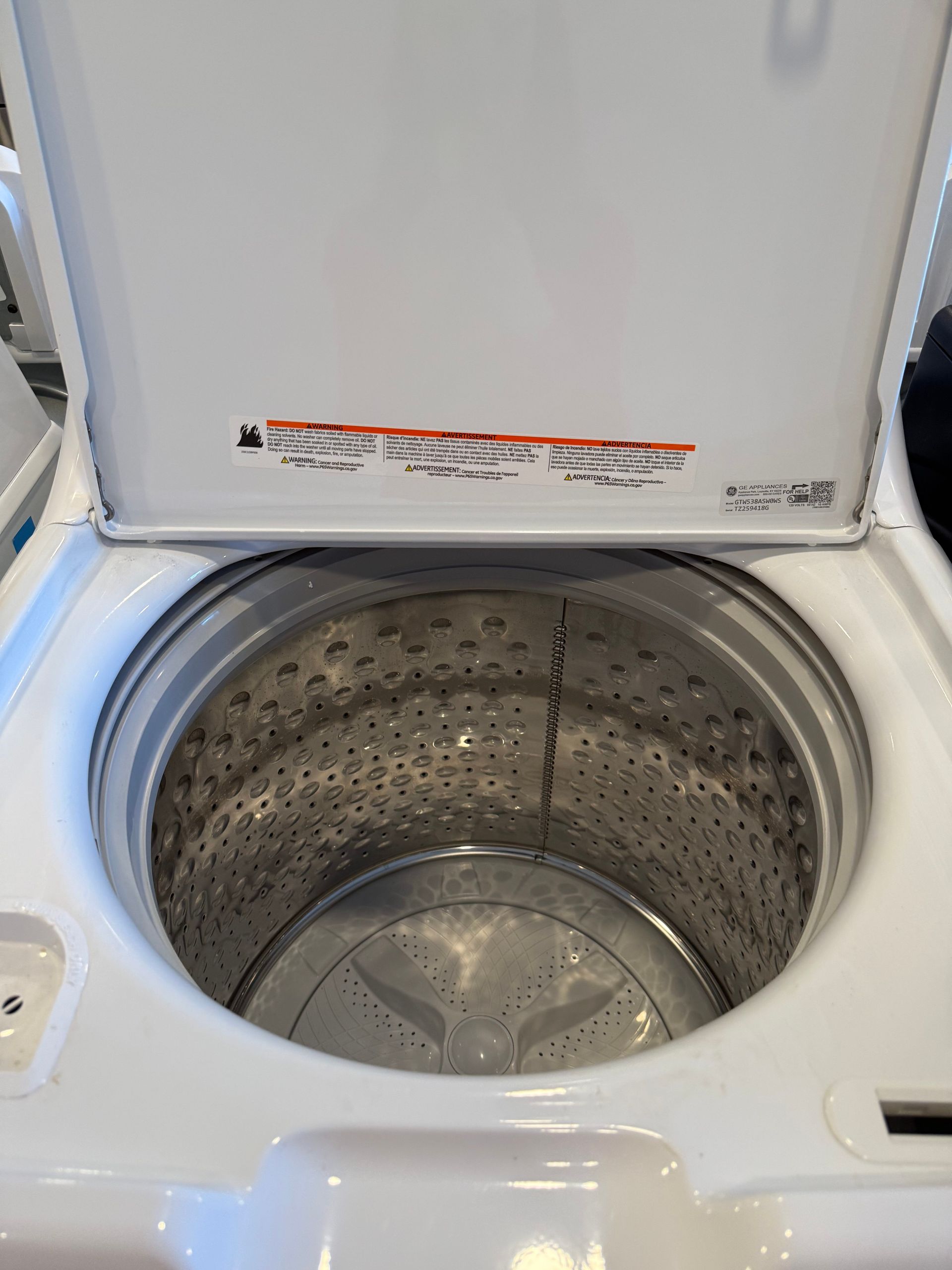 The inside of a washing machine with the lid open.