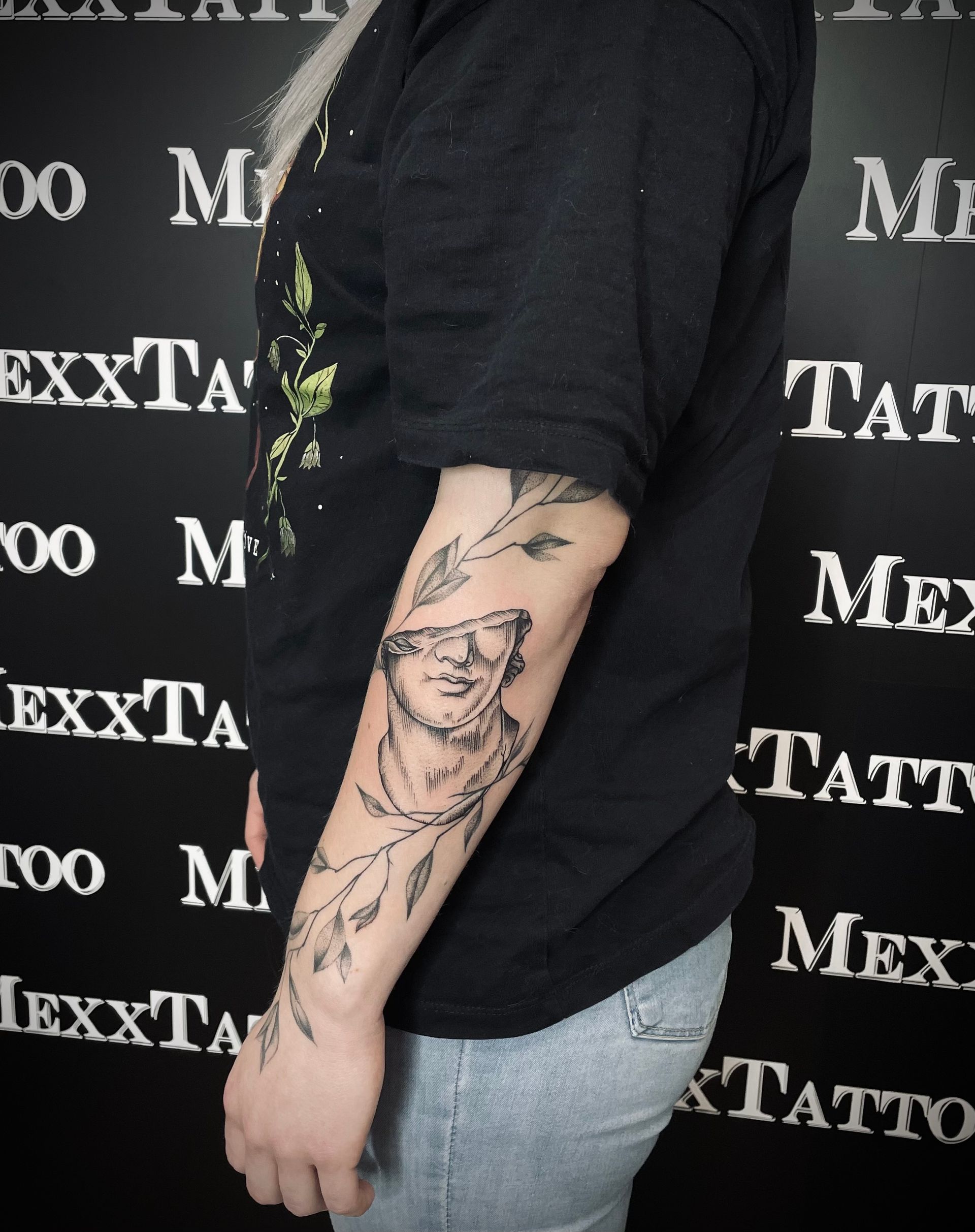 eine Frau mit einem Tattoo auf ihrem Arm