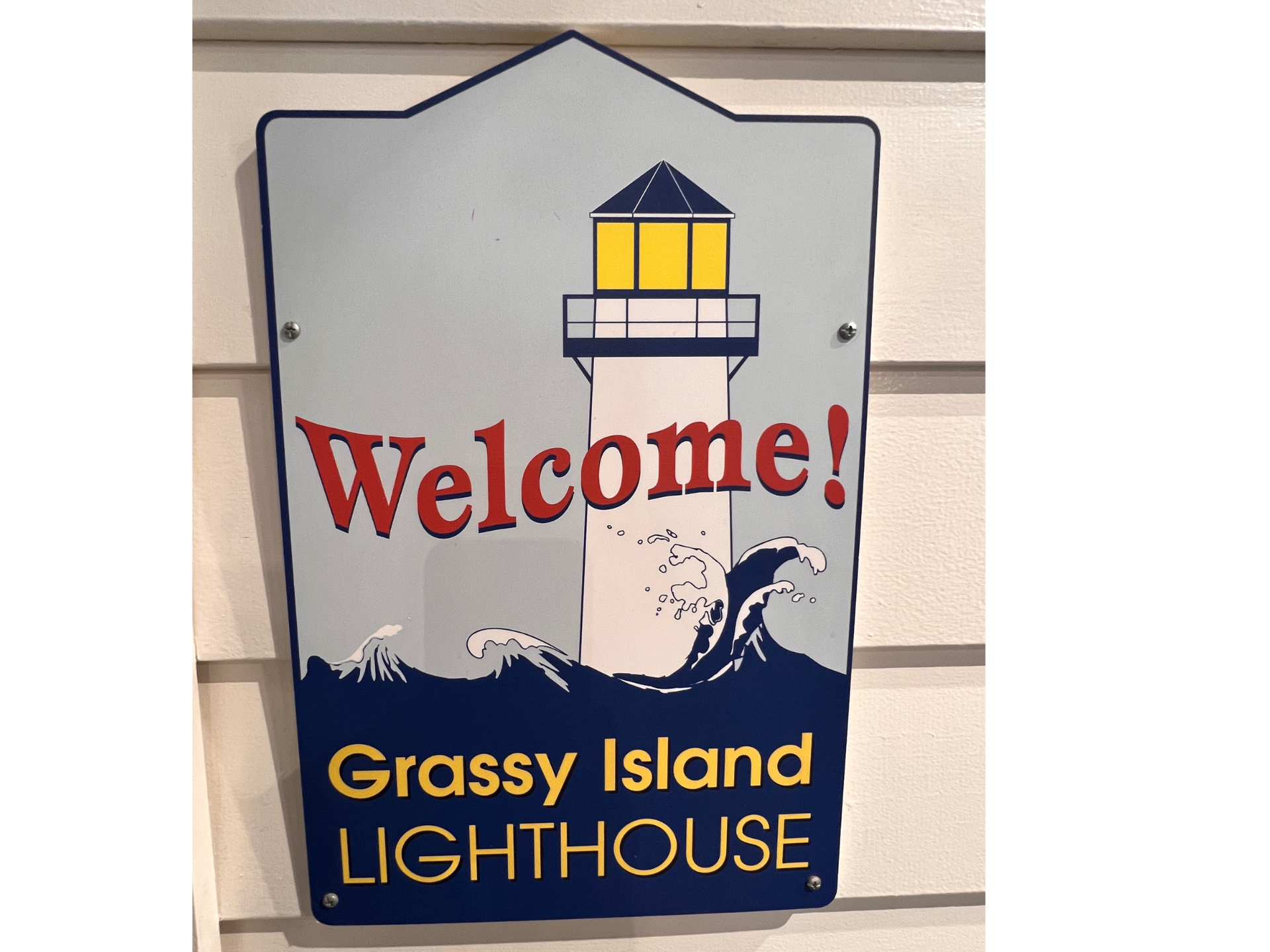 A welcome sign for the grassy island lighthouse