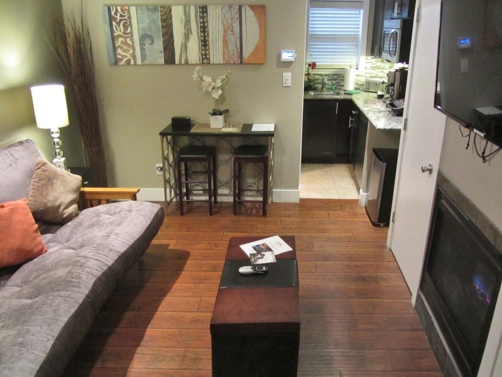 A living room with a couch a table and a fireplace