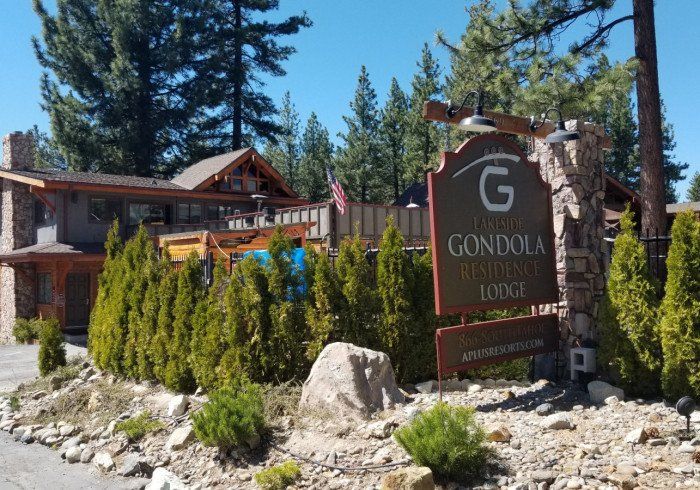 A sign in front of a building that says gondola lodge