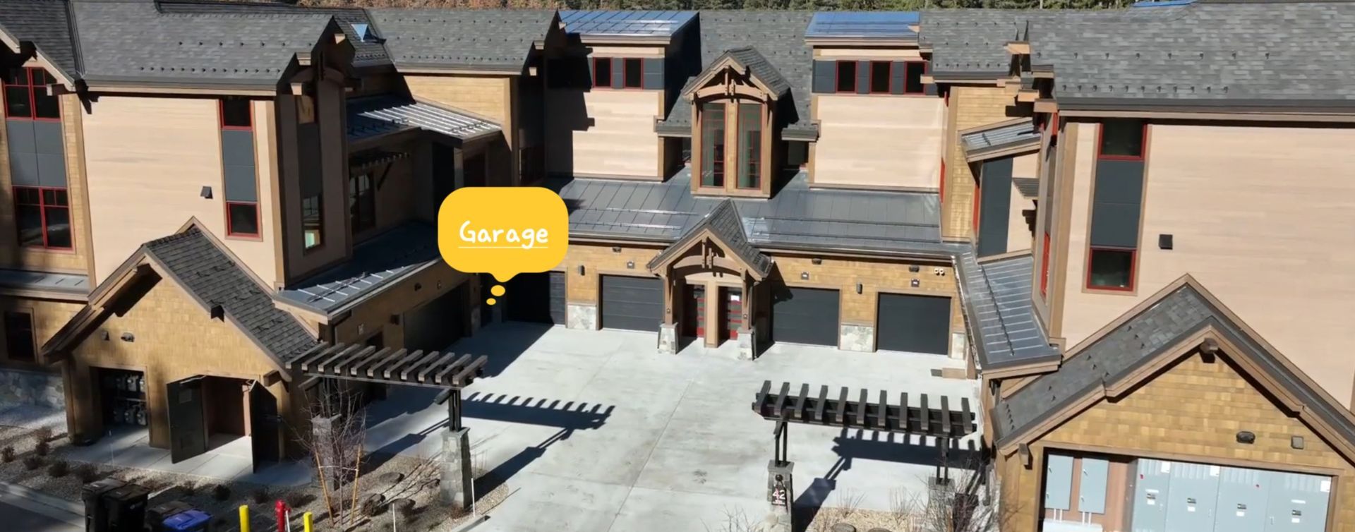 An aerial view of a large house with a lot of garages.
