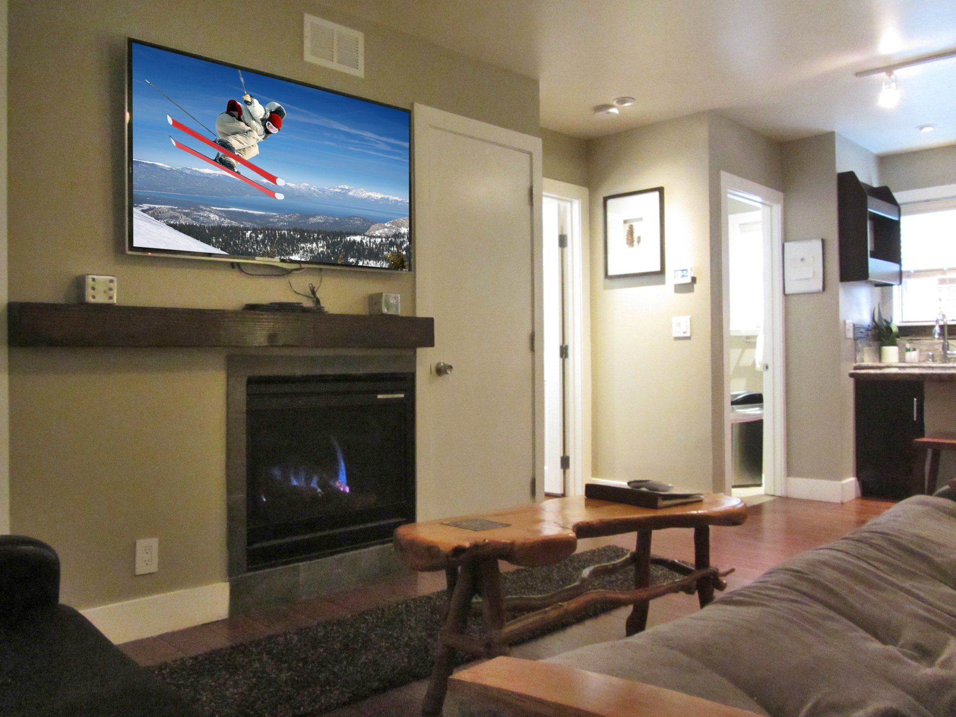 A living room with a fireplace and a flat screen tv