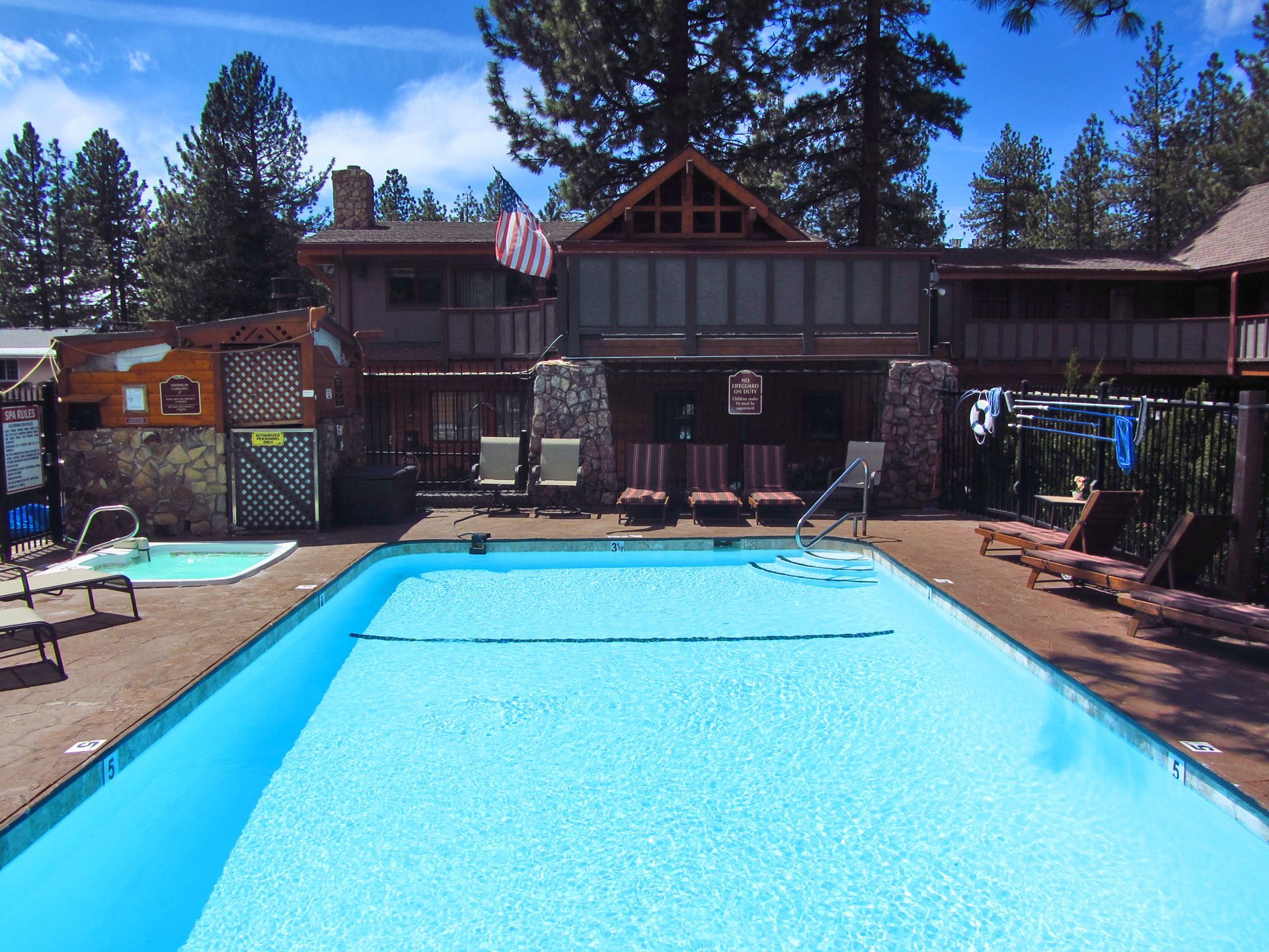 A large swimming pool in front of a house