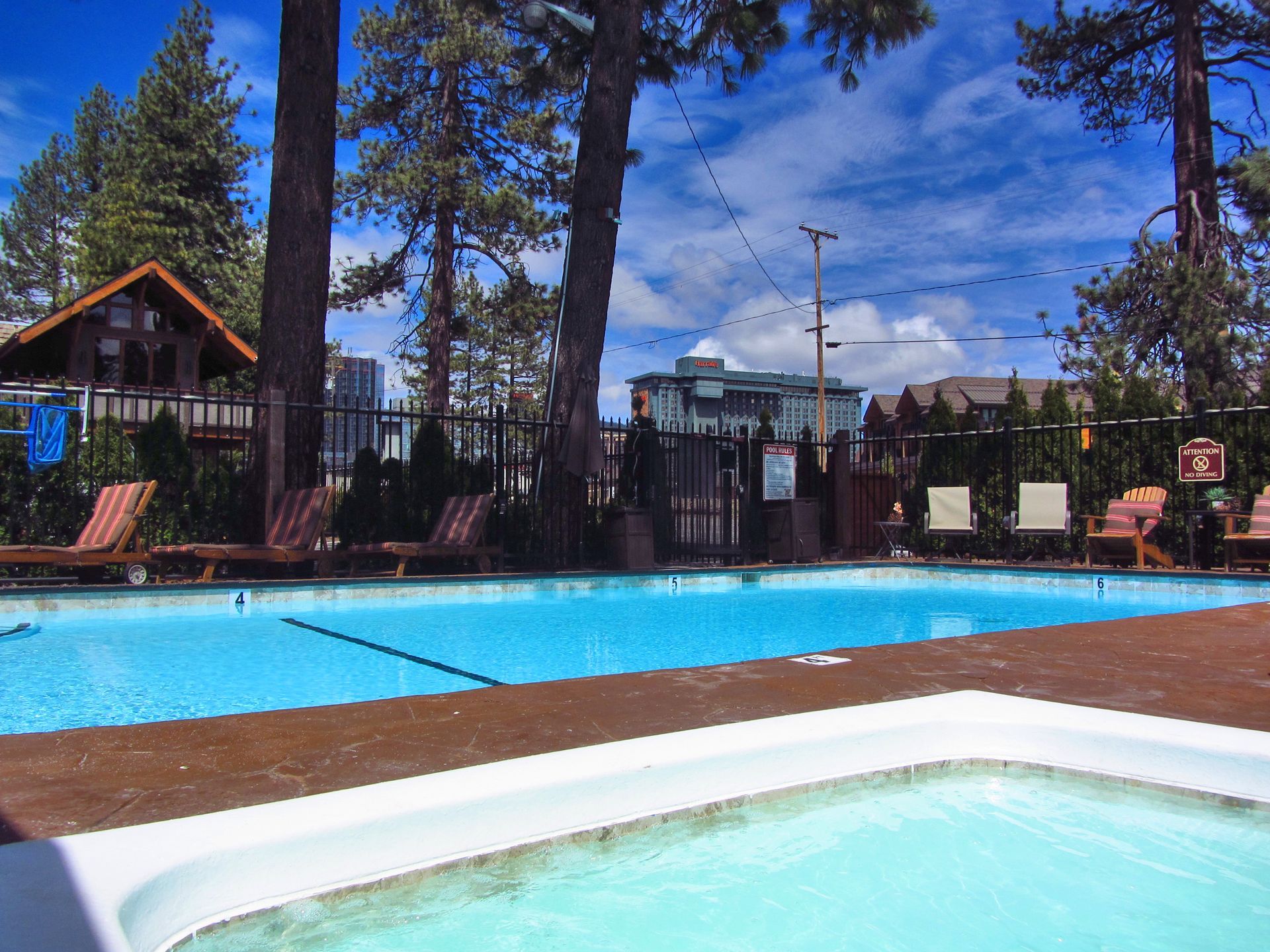A large swimming pool with a hot tub in the foreground