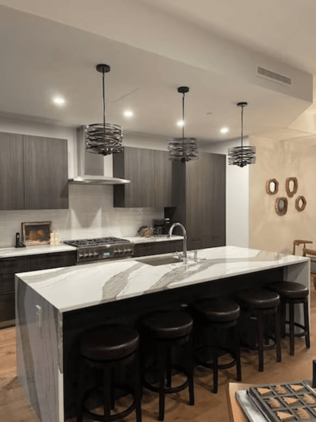 A kitchen with a large island and stools