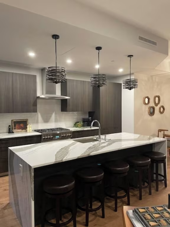 A kitchen with a large island and stools