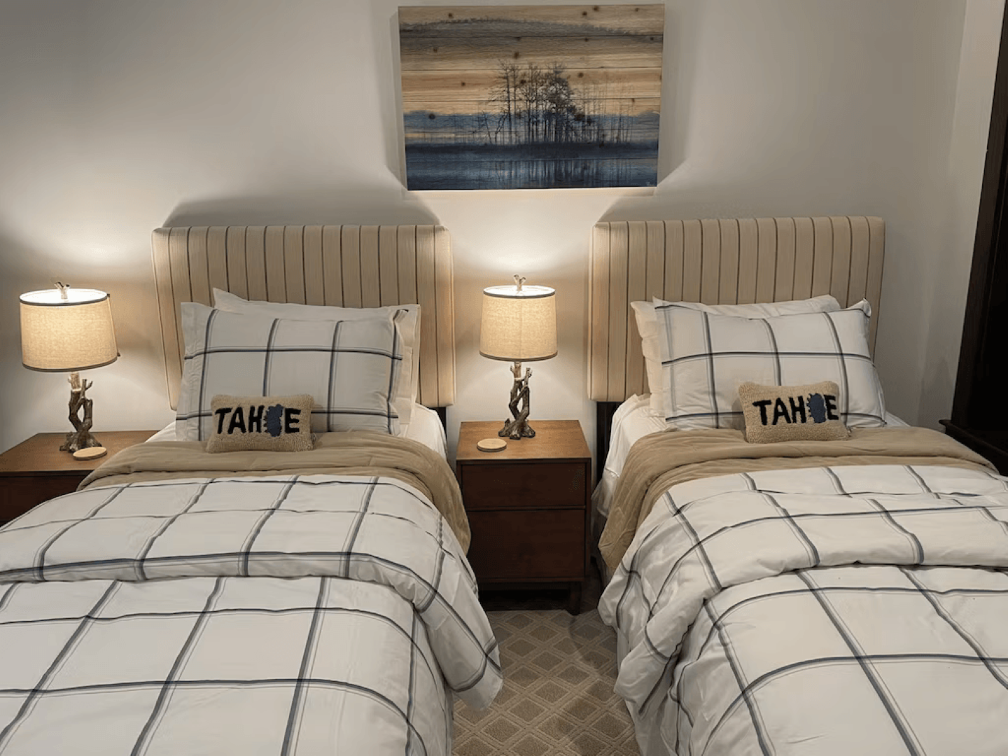 A bedroom with two twin beds and two nightstands.