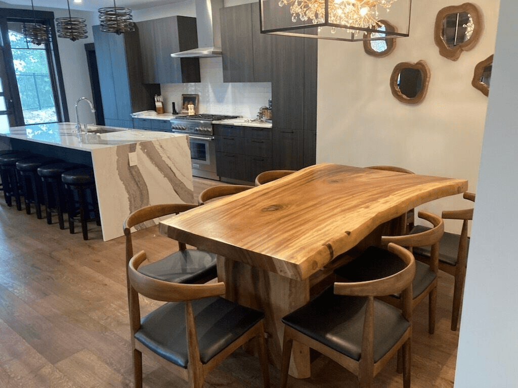 A kitchen with a wooden table and chairs in it