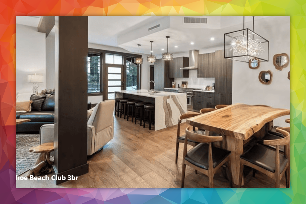 A living room with a wooden table and chairs and a kitchen.