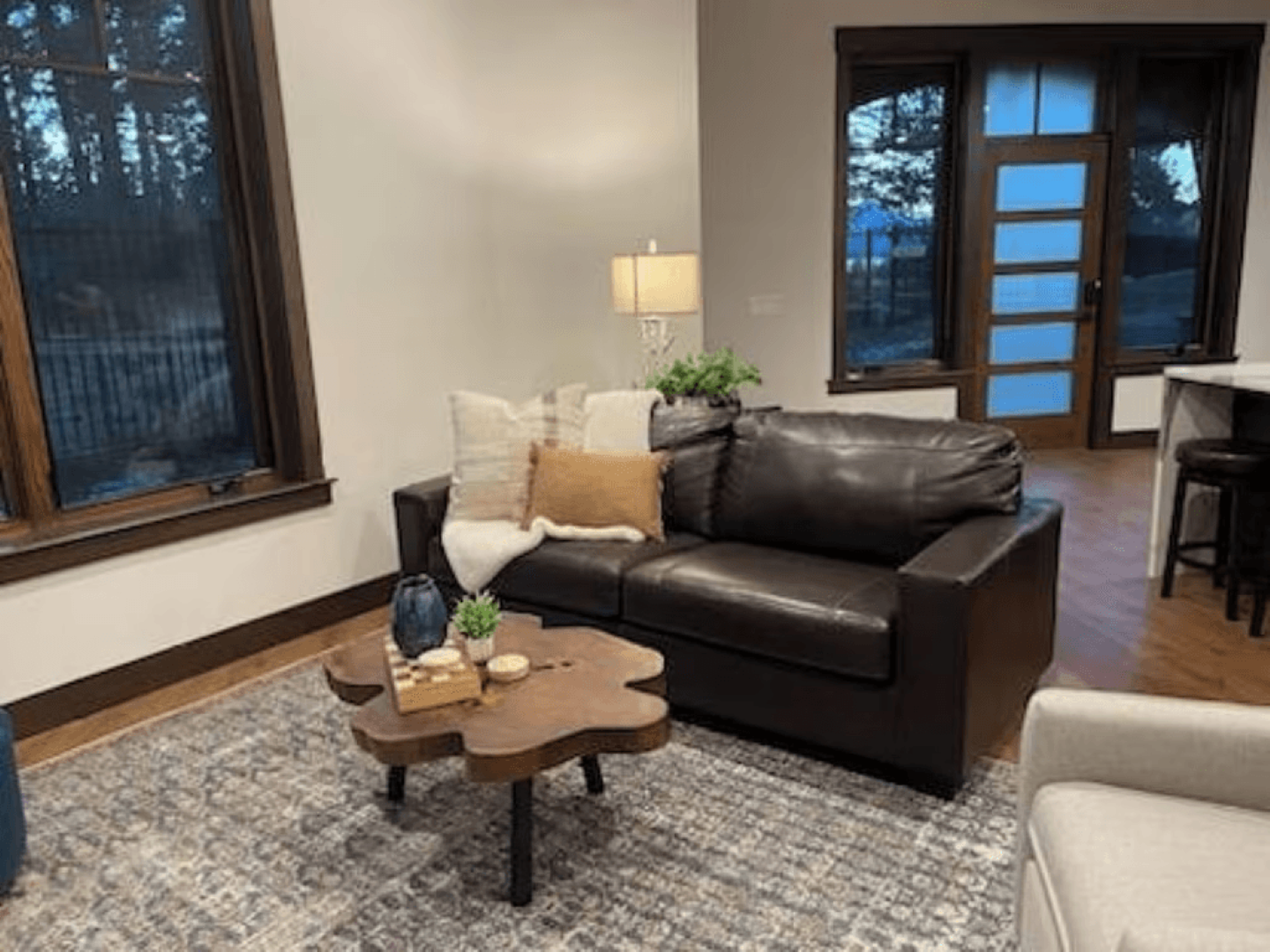 A living room with a brown leather couch and a wooden coffee table.