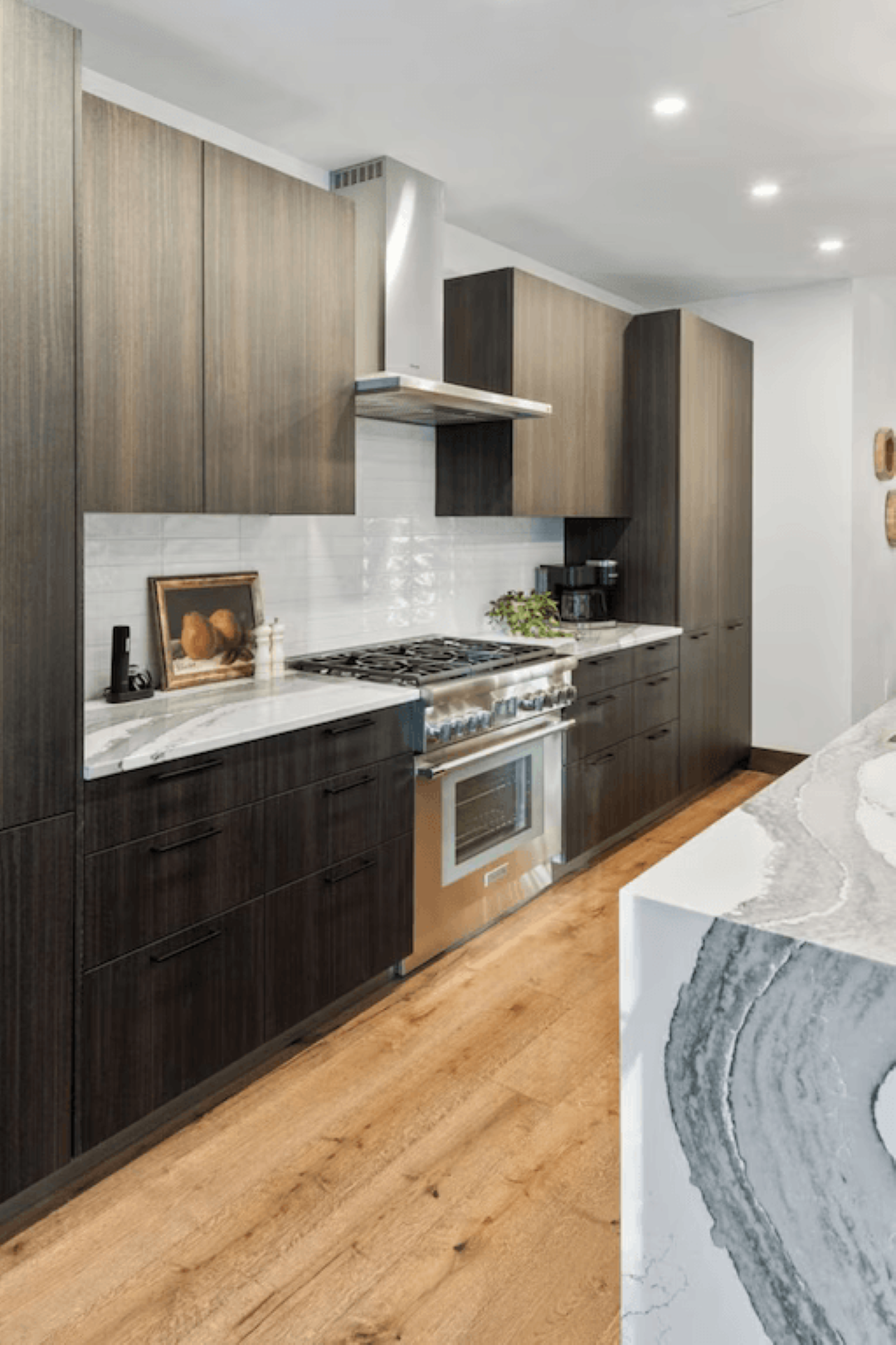A kitchen with stainless steel appliances and wooden cabinets.