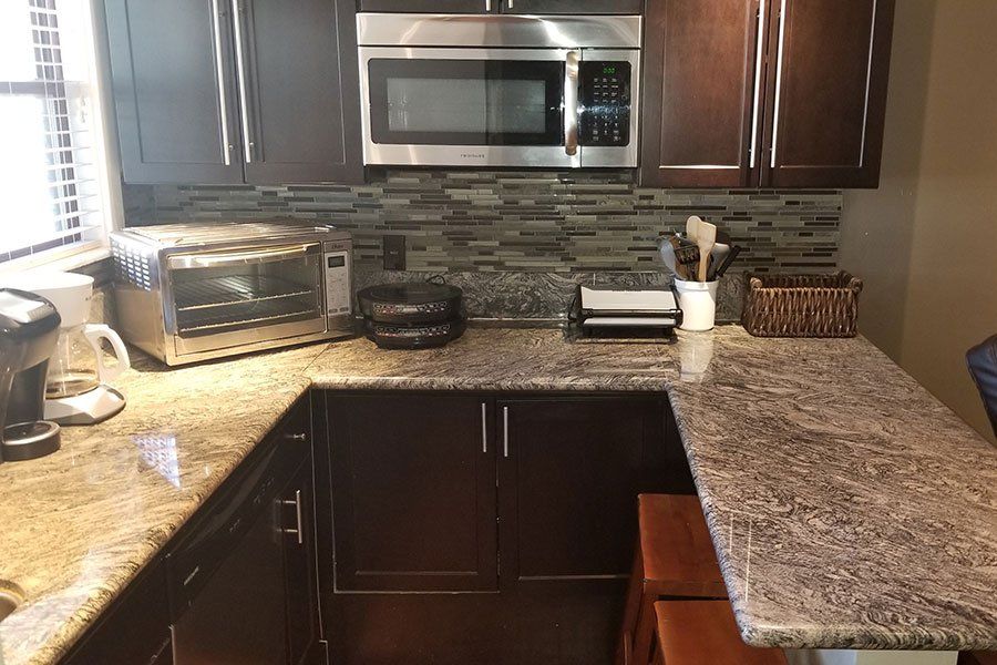 A kitchen with stainless steel appliances and granite counter tops