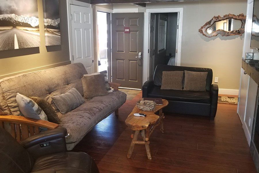 A living room with a couch , chairs , and a coffee table.