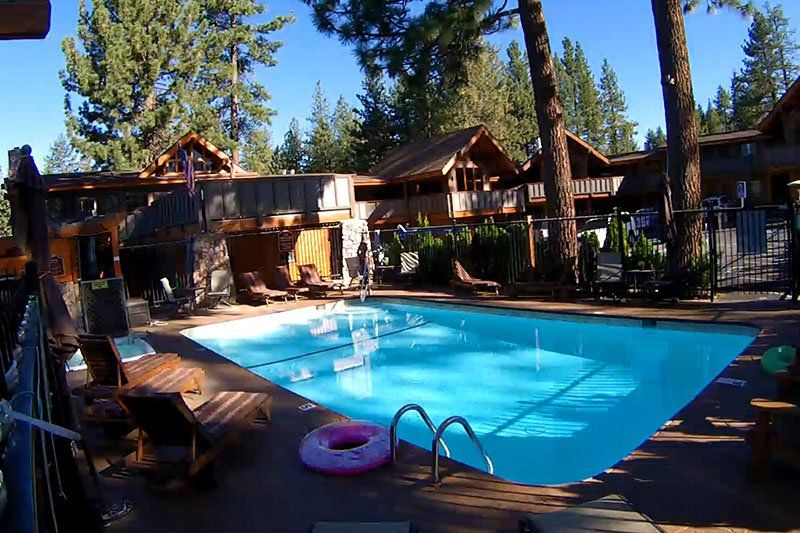A large swimming pool with a pink life preserver in it