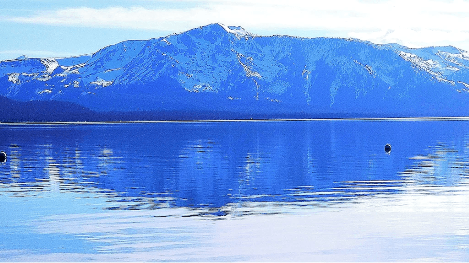 A large body of water with mountains in the background