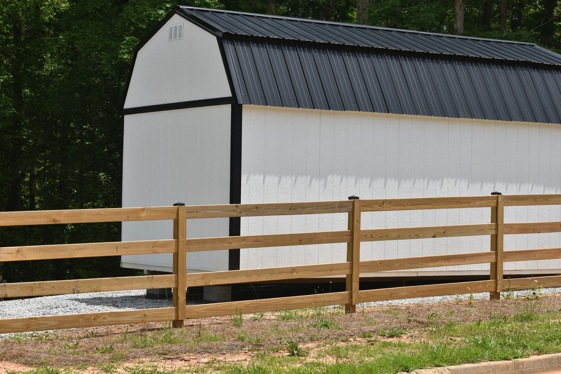 A white lattice fence is in front of a wooden house.