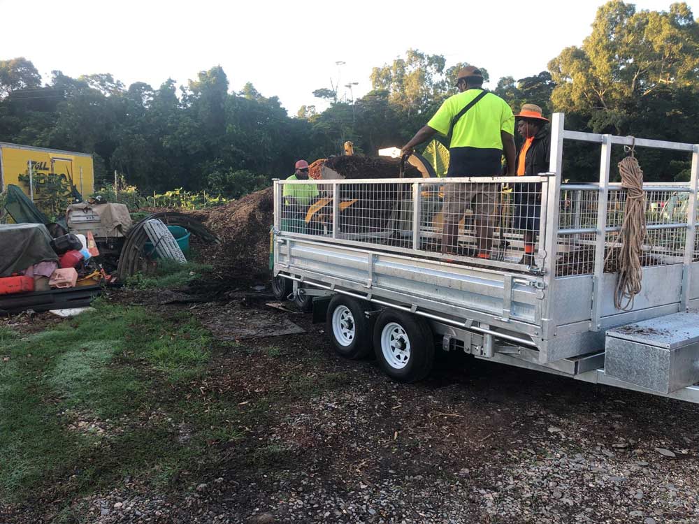 Workers Loading The Waste From The Tree Into The Truck — NQ Parks and Gardens in Cairns, QLD