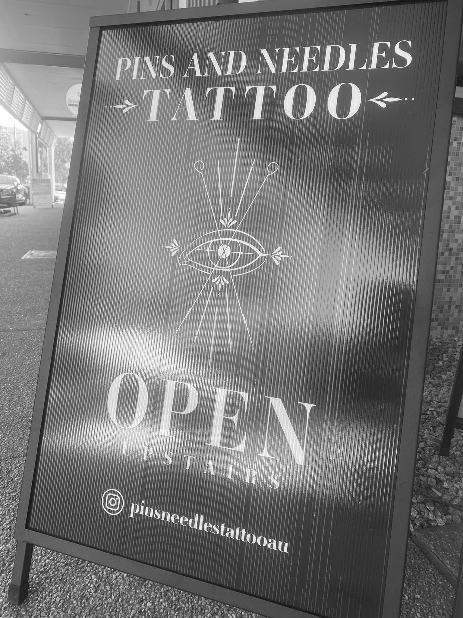 Black and White Sign for Pins and Needles Tattoo — Pins and Needles Tattoo in Trinity Beach, QLD