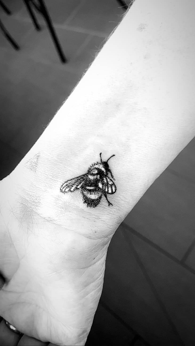 Black and White Tattoo of a Bee on a Wrist — Pins and Needles Tattoo in Kewarra Beach, QLD