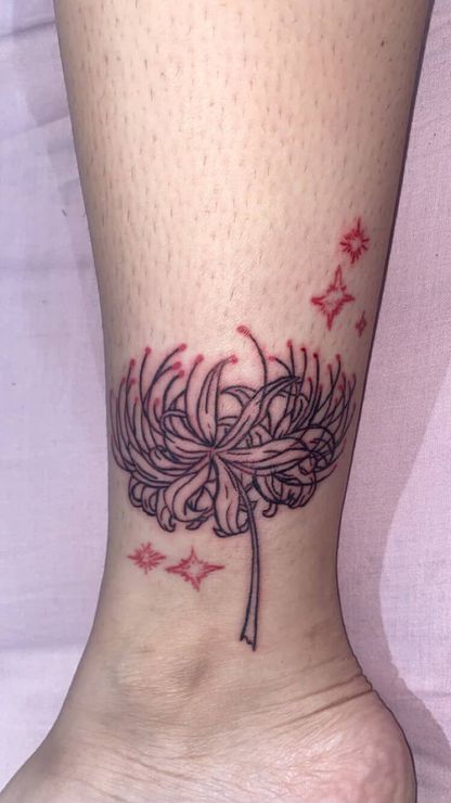 Black palm tree tattoo on a light-skinned leg, likely on the calf.