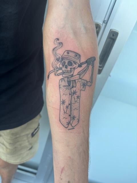 Tattoo of a skeleton playing golf, smoking, wearing a visor and Hawaiian shirt, on an arm. — Pins and Needles Tattoo in Smithfield, QLD