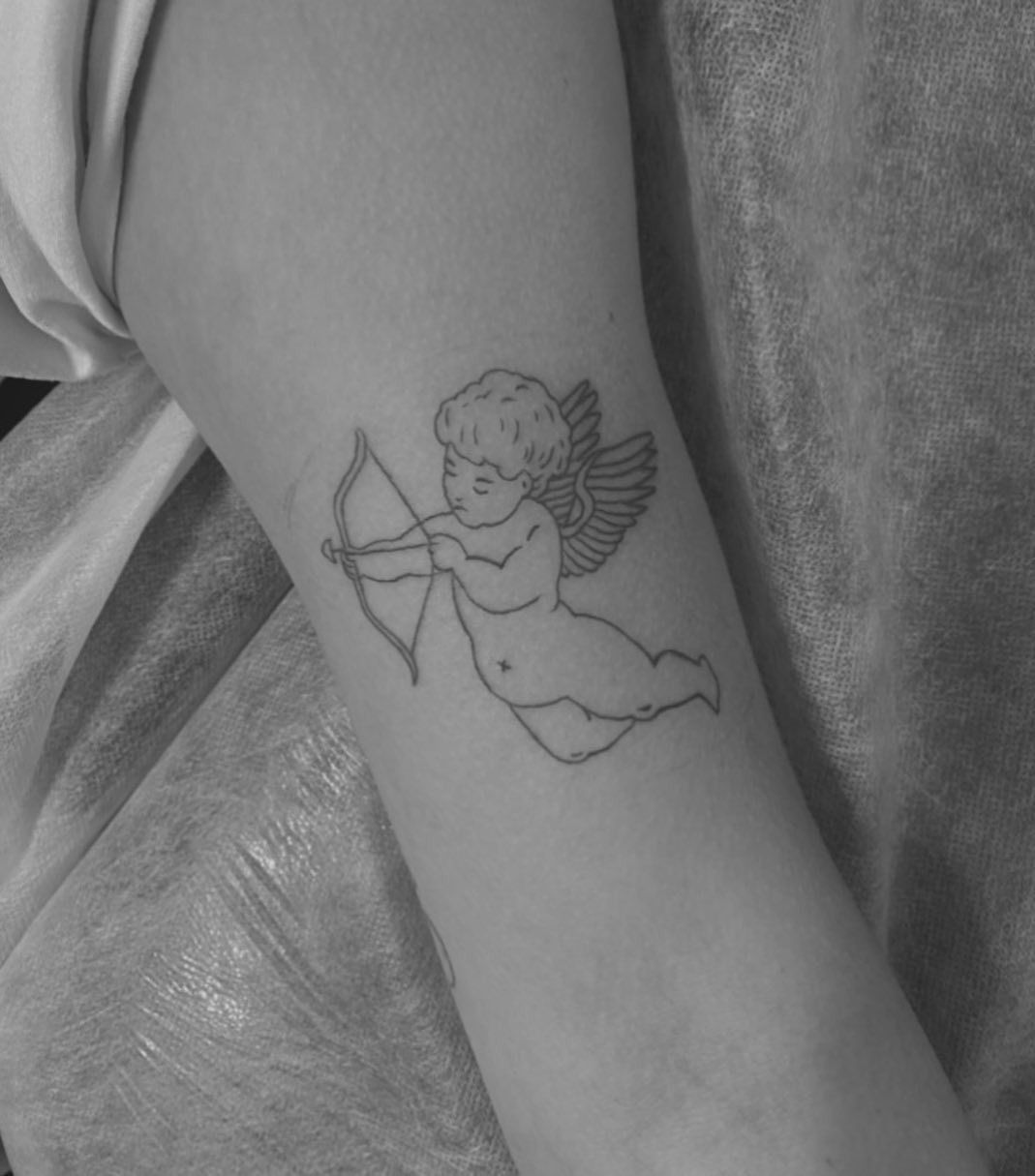 Line Art Tattoo of a Cherub Aiming a Bow and Arrow on an Arm — Pins and Needles Tattoo in Smithfield, QLD