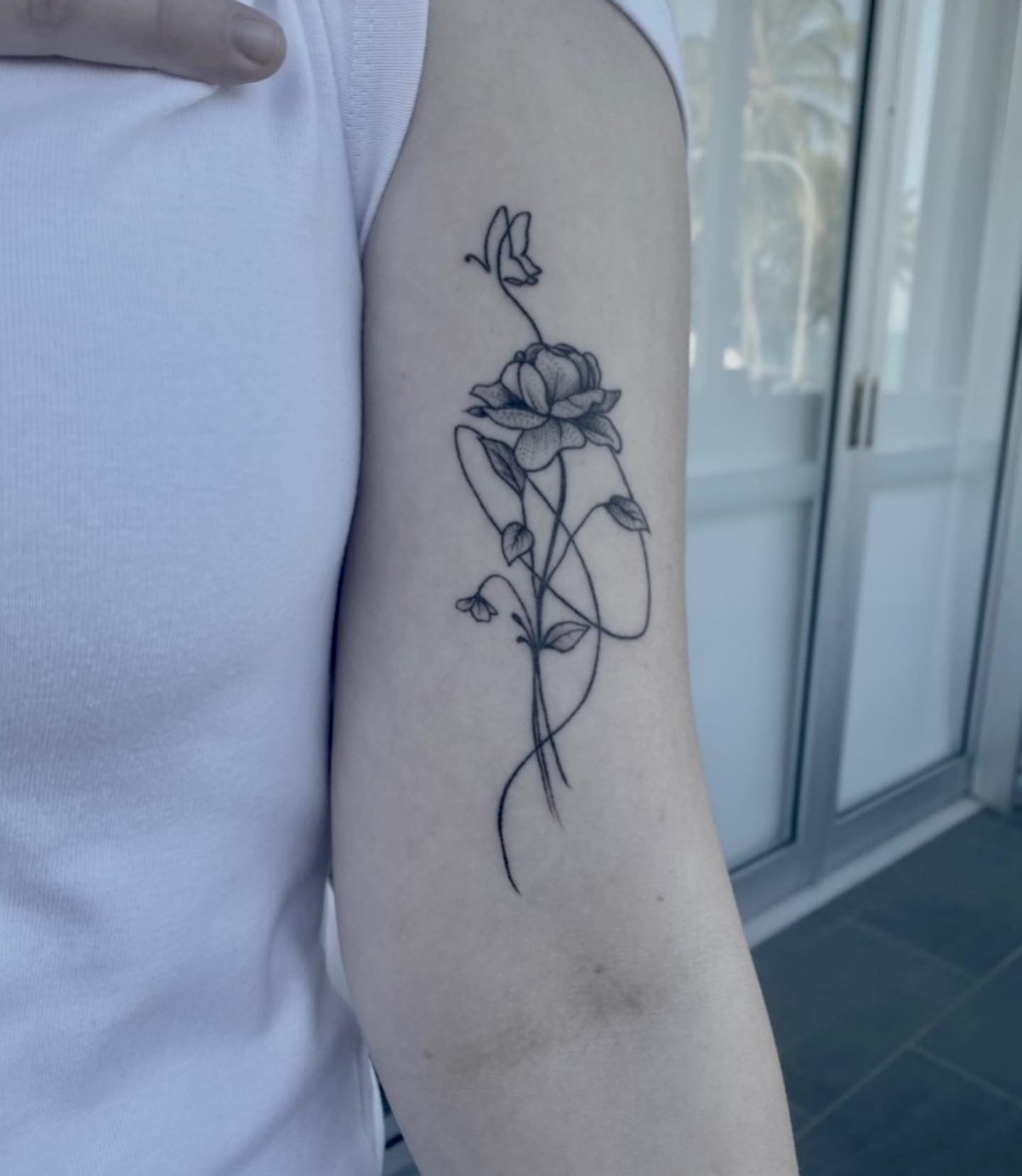 Line Art Tattoo of a Flower With Vines on a Person's Arm — Pins and Needles Tattoo in Trinity Beach, QLD