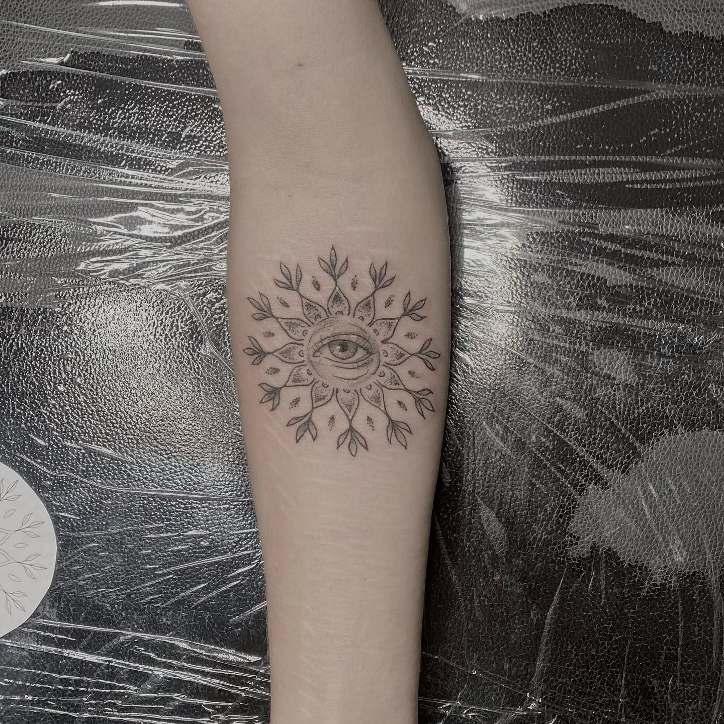 Tattoo of an Eye Within a Circular Floral Design on an Arm — Pins and Needles Tattoo in Cairns, QLD 