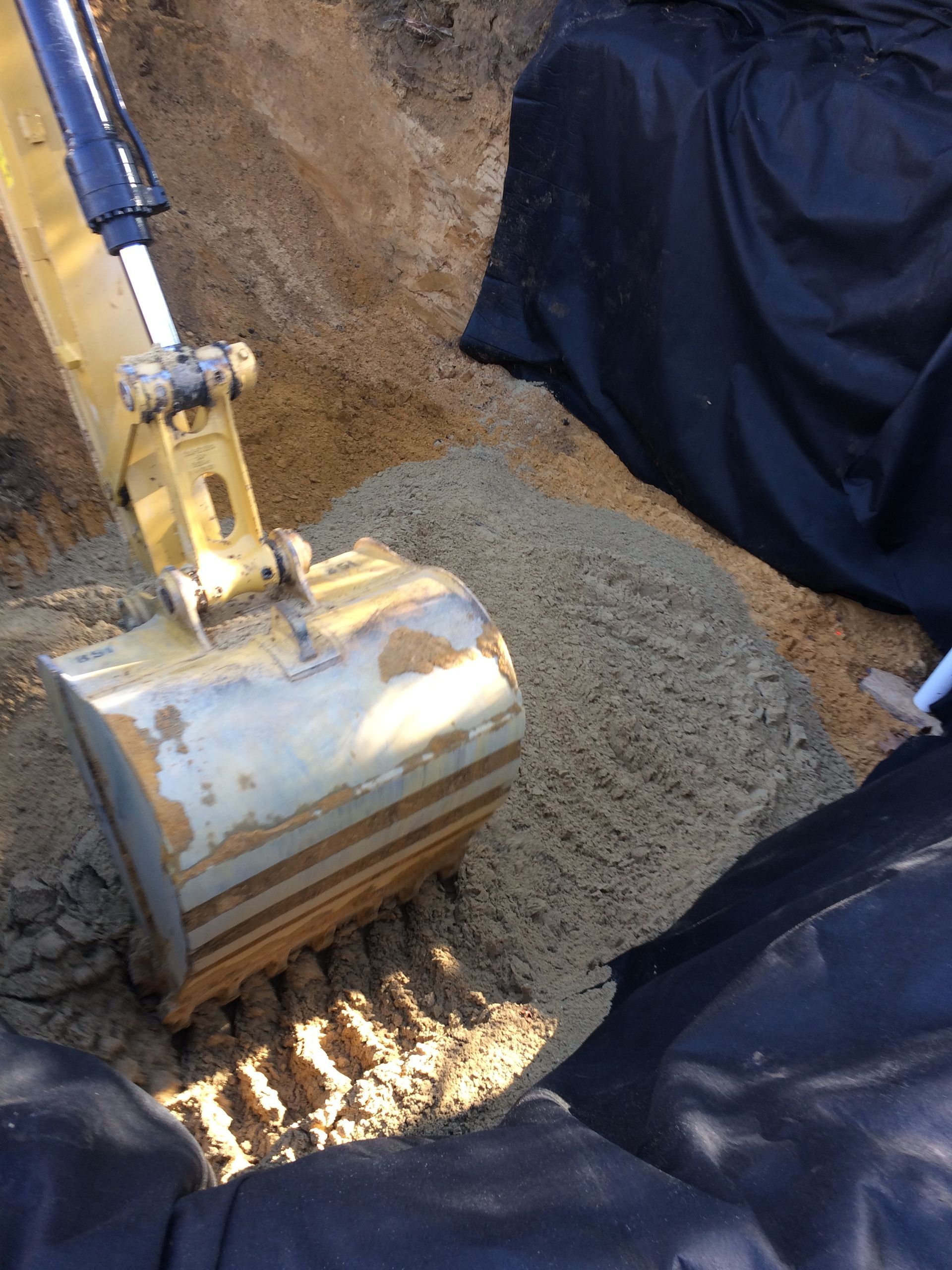 A person is using a bulldozer to dig a hole in the ground
