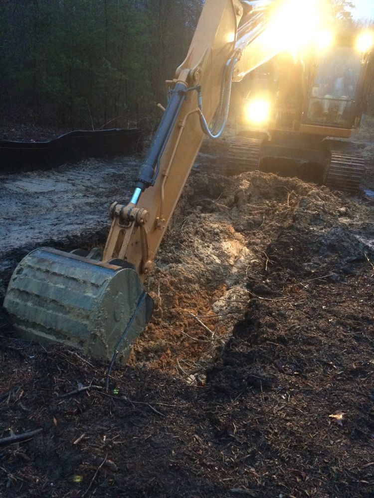 A large excavator is digging a hole in the ground.