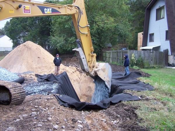 A cat excavator is digging a hole in the ground