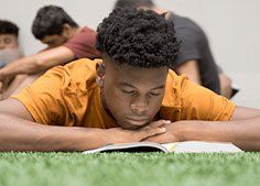 FCA student reading a textbook on turf