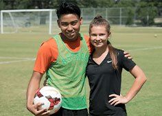 2 FCA soccer athletes smiling at camera