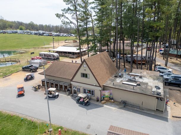 An aerial view of a large building with golf carts parked in front of it.