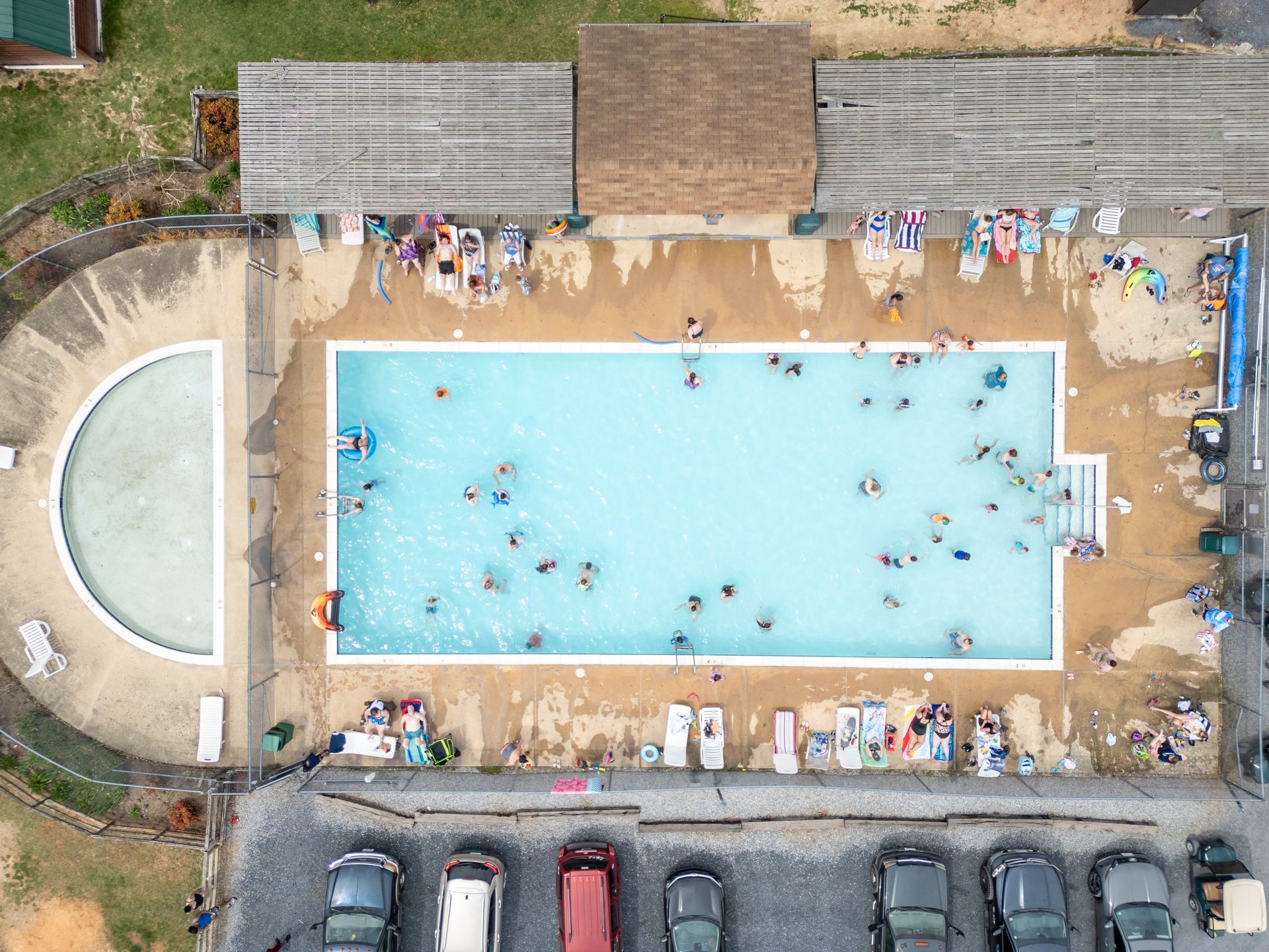 An aerial view of a swimming pool filled with people.
