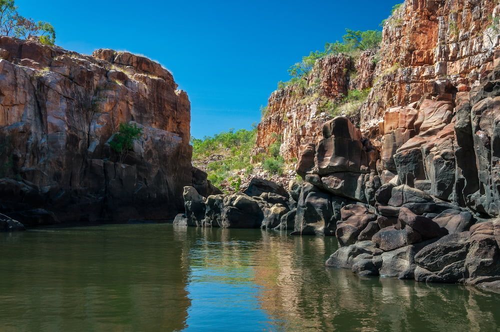 A River Surrounded By Rocks And Trees With A Blue Sky In The Background — Aust Outback Pest Co In Katherine, NT
