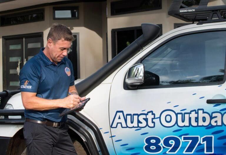 A Man Is Standing Next To A Truck That Says Aust Outback 8971 — Aust Outback Pest Co In Howard Springs, NT