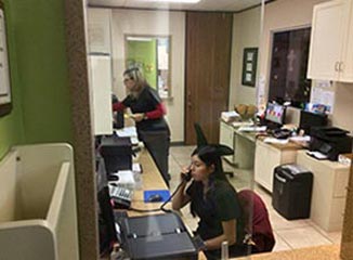 Staff Taking A Phone Call — Pediatric Dentist In Mcallen, TX Staff Taking A Phone Call — Pediatric Dentist In Mcallen, TX