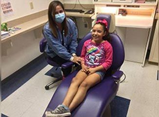 Dentist And The Patient Sitting On The Dental Chair — Pediatric Dentist In Mcallen, TX